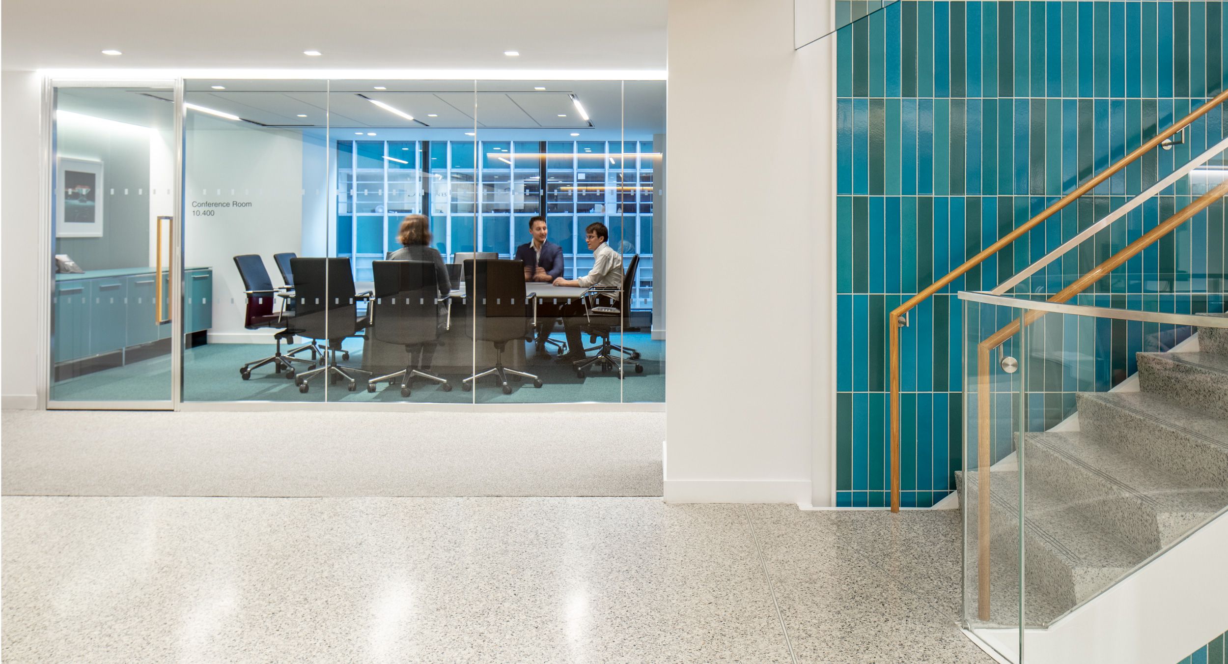 A custom HALCON credenza is perfectly color-matched in teal blue and paired with a  timeless HALO table.